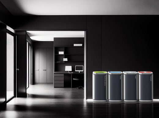 Four recycling bins joined together in executive office environment